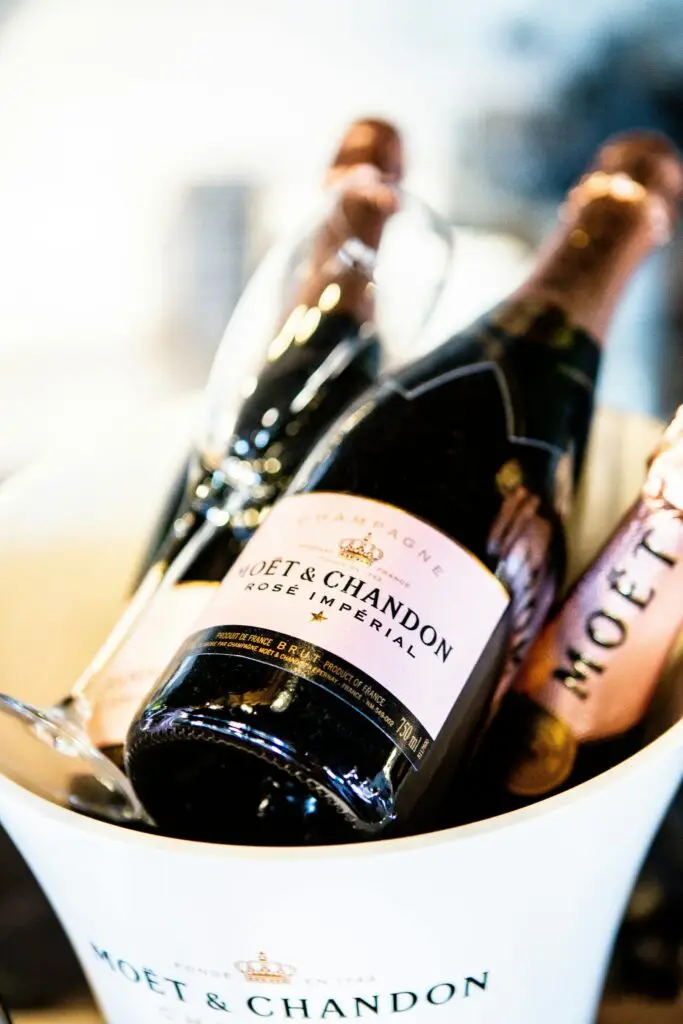 Close-up of Moët & Chandon Champagne bottles in an ice bucket, epitomizing luxury and celebration.